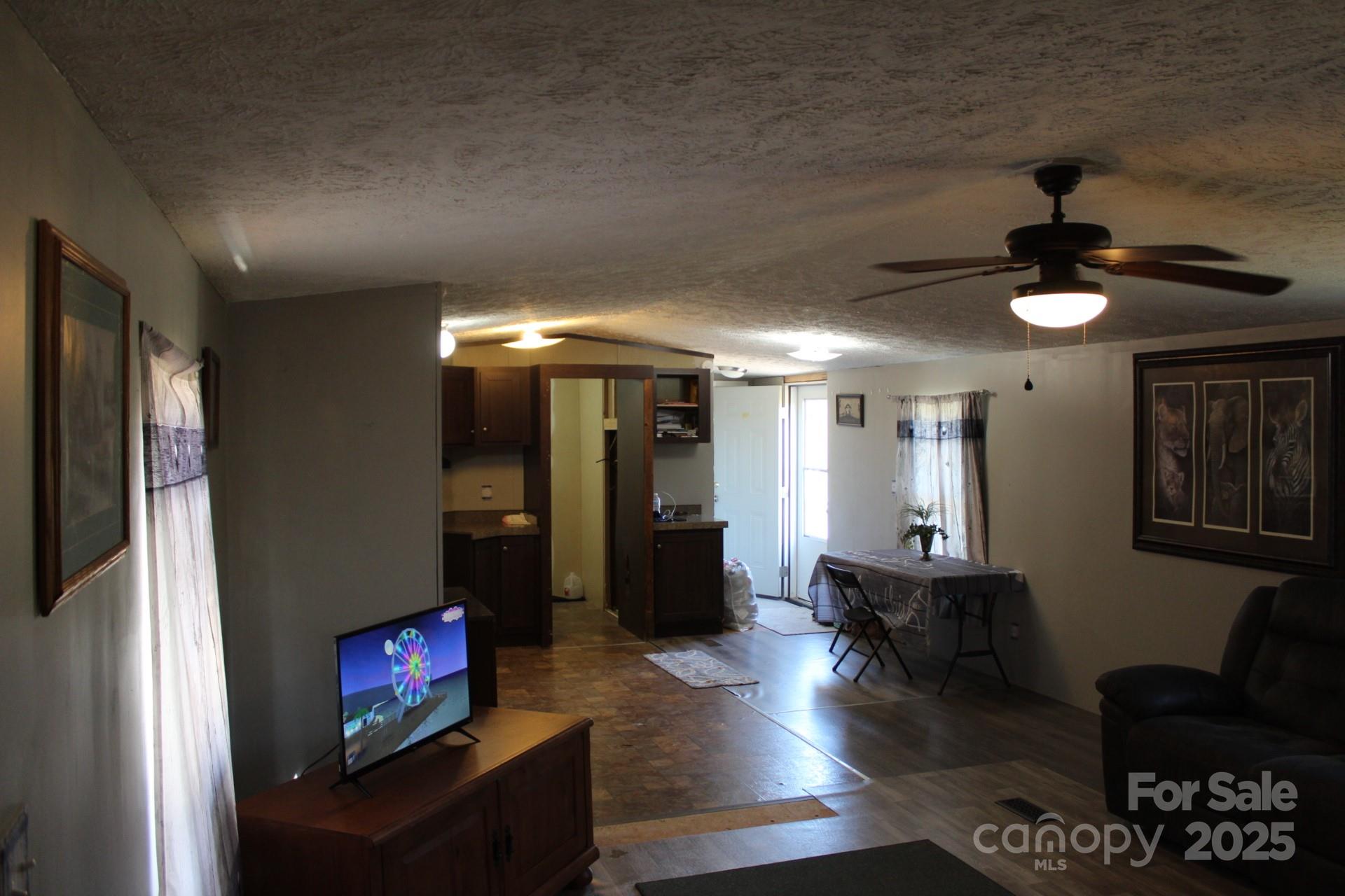 260 Buck Br Road Mill Spring, NC 28756 - Photo 15 of 32 a living room with furniture and a flat screen tv