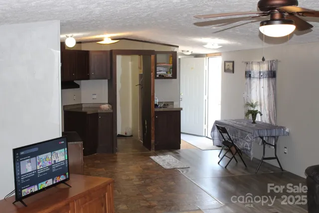 a view of a room with wooden floor and furniture