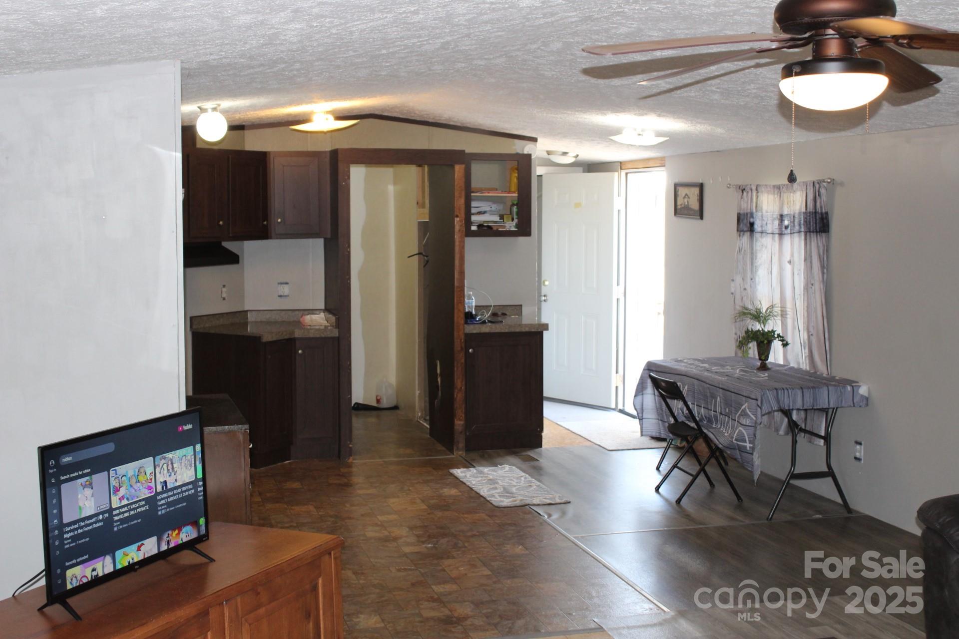 260 Buck Br Road Mill Spring, NC 28756 - Photo 17 of 32 a view of a room with wooden floor and furniture