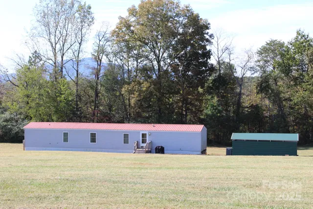 a front view of a house with trees in the background