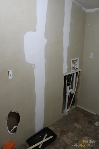 a view of a room with wooden floor and windows