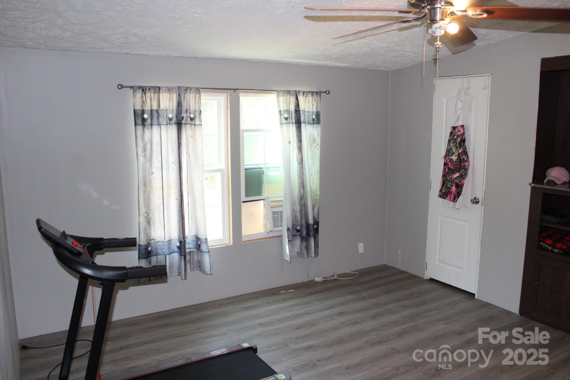 260 Buck Br Road Mill Spring, NC 28756 - Photo 23 of 32 a view of a room with wooden floor and windows