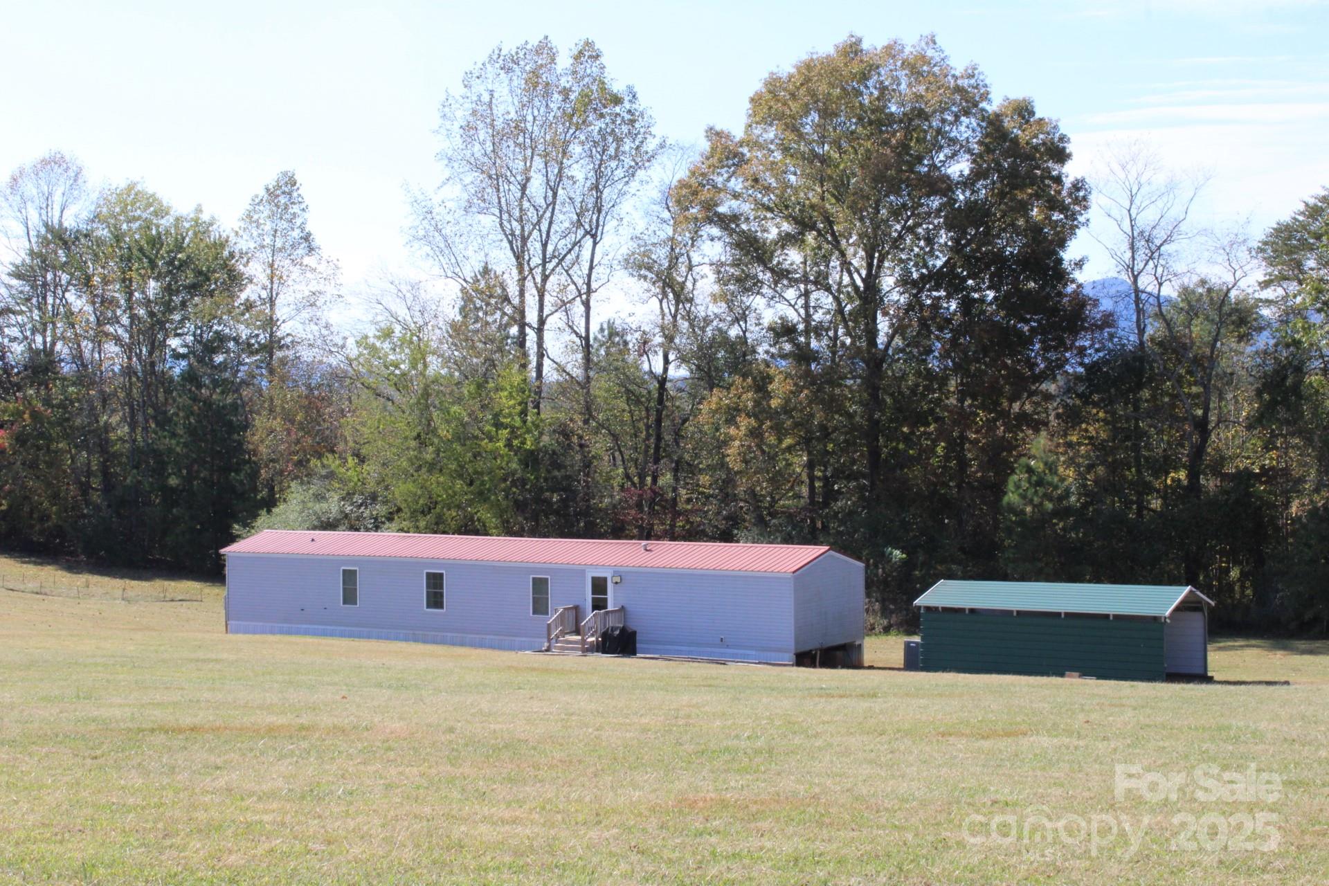 260 Buck Br Road Mill Spring, NC 28756 - Photo 3 of 32 a front view of a house with a yard