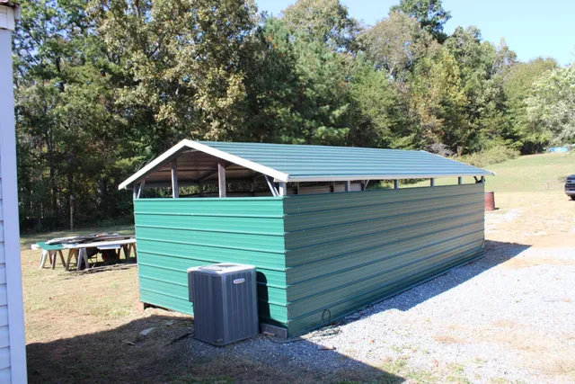 a view of house with backyard and seating area