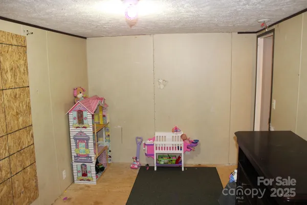 a bedroom with furniture a rug and a window