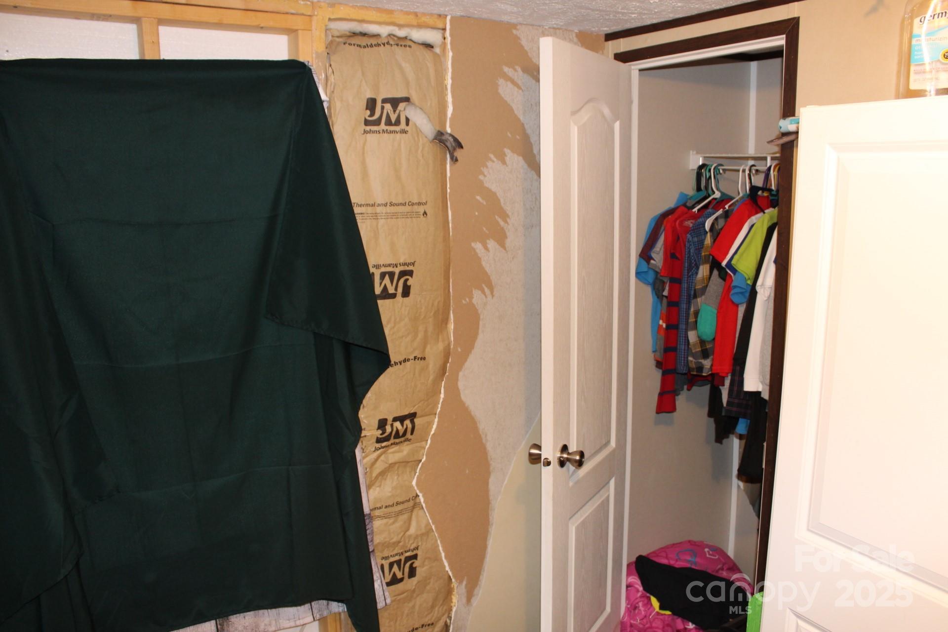 260 Buck Br Road Mill Spring, NC 28756 - Photo 10 of 32 a view of walk in closet with clothes and shoes
