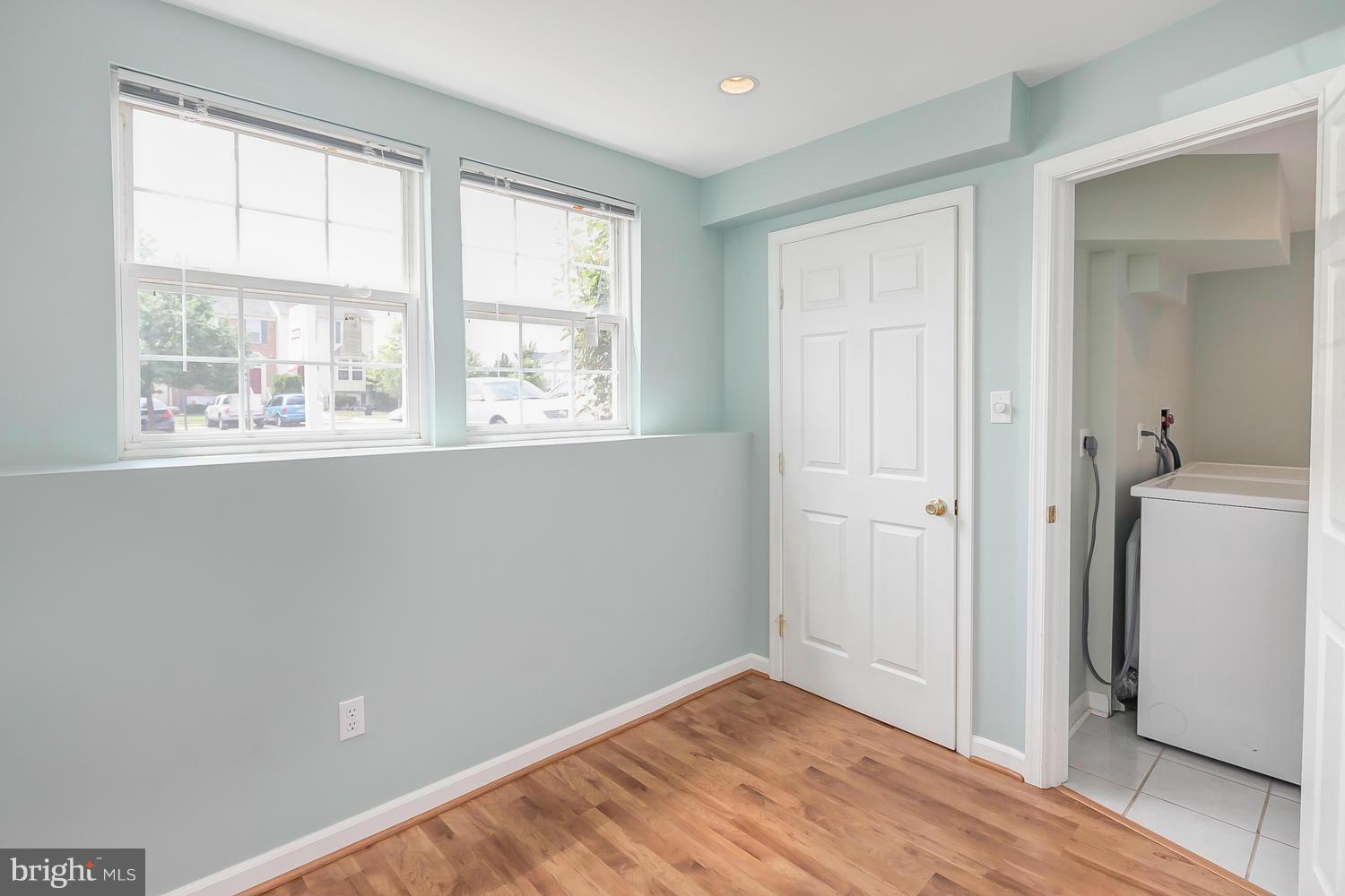 6386 Trips Way Springfield, VA 22150 - Photo 22 of 29 a view of an empty room with wooden floor and a window