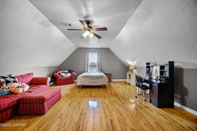 a bathroom with a sink a toilet a mirror and shower
