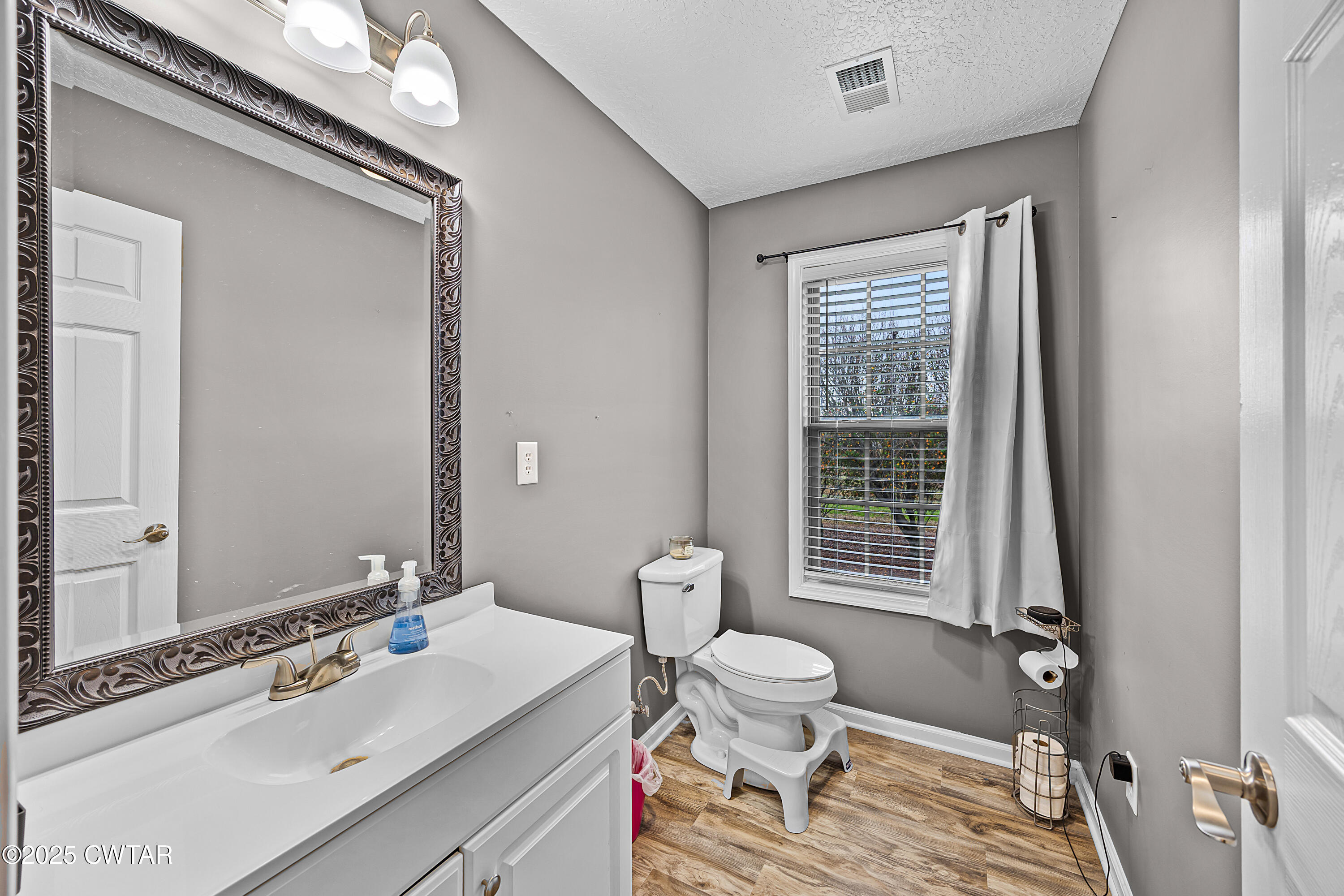 31 Turkey Creek Road Medina, TN 38355 - Photo 20 of 21 a bathroom with a sink a toilet a mirror and shower