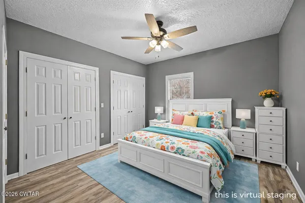 a bedroom with furniture and a wooden floor