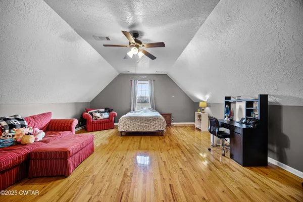 a bathroom with a sink a toilet a mirror and shower