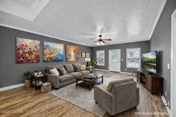 a living room with furniture a flat screen tv and large window