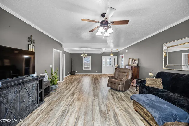 a kitchen with stainless steel appliances granite countertop a stove top oven a sink dishwasher and white cabinets with wooden floor