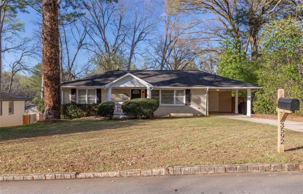 3592 Barrington Place Decatur, GA 30032 - Photo 1 of 32 a front view of a house with a yard