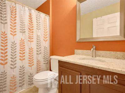 31 Edinburgh Court Edison, NJ 08820 - Photo 23 of 25 a bathroom with a sink a toilet and a mirror