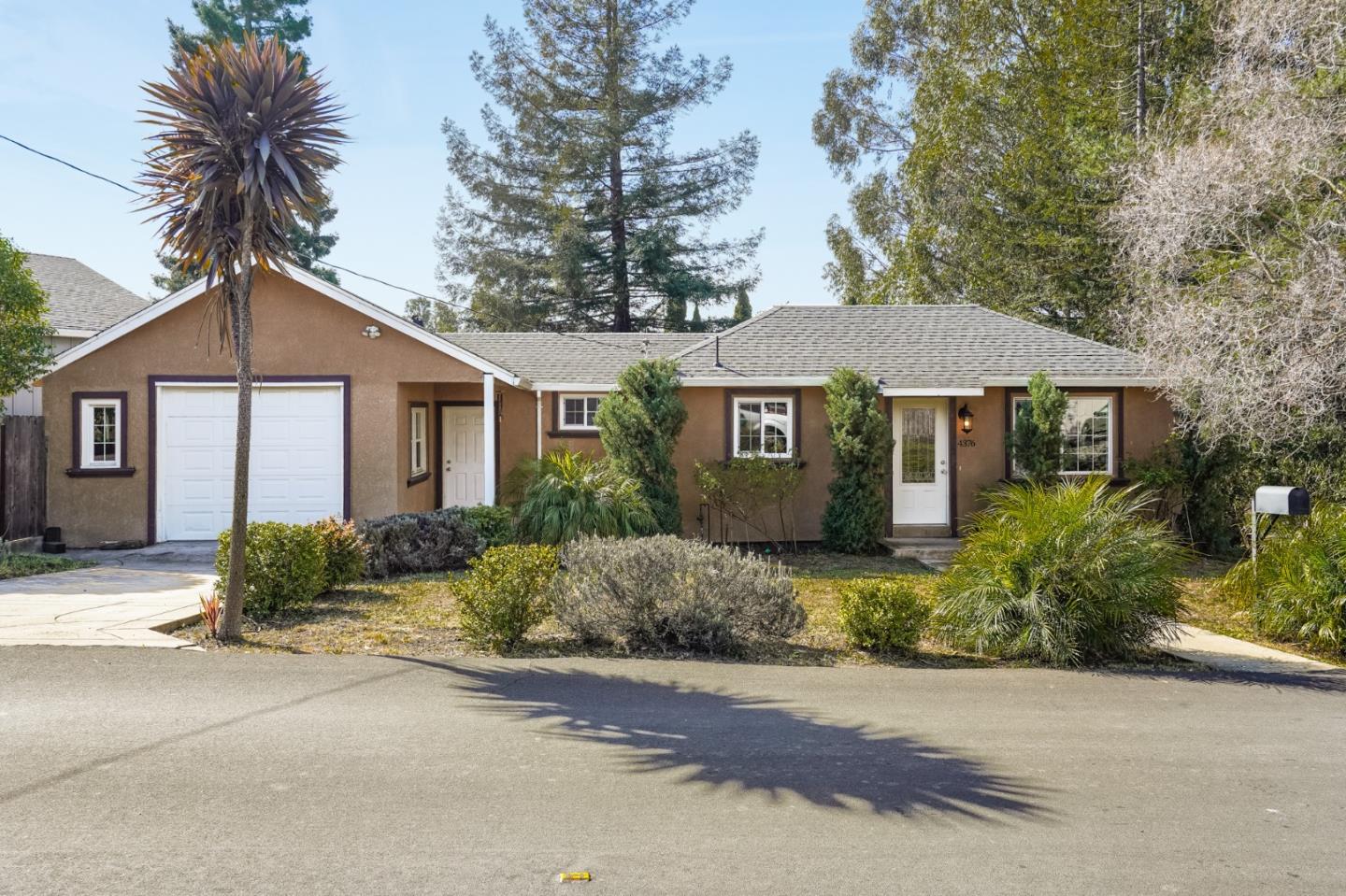 4376 Santa Rita Road El Sobrante, CA 94803 - Photo 3 of 48 a front view of a house with a yard and garage