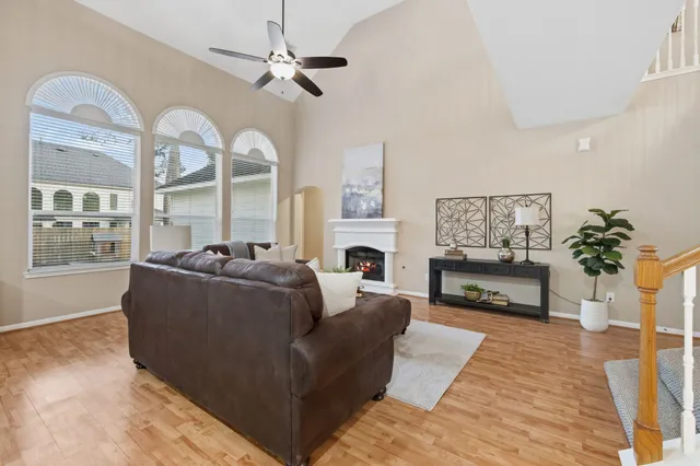 a living room with furniture a fireplace and a chandelier