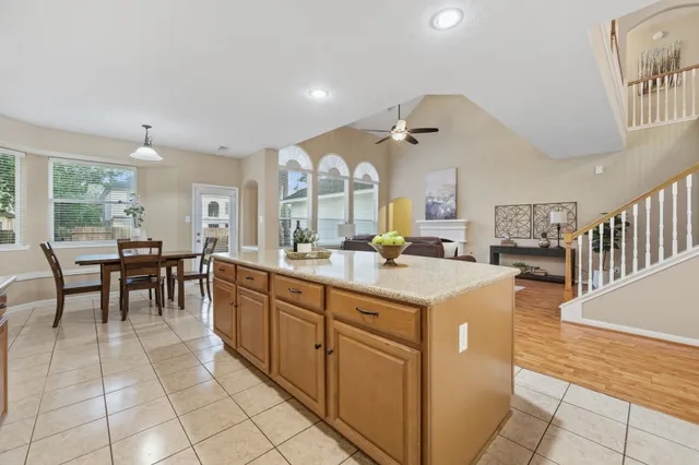 a large kitchen with kitchen island a large counter space a sink appliances and cabinets