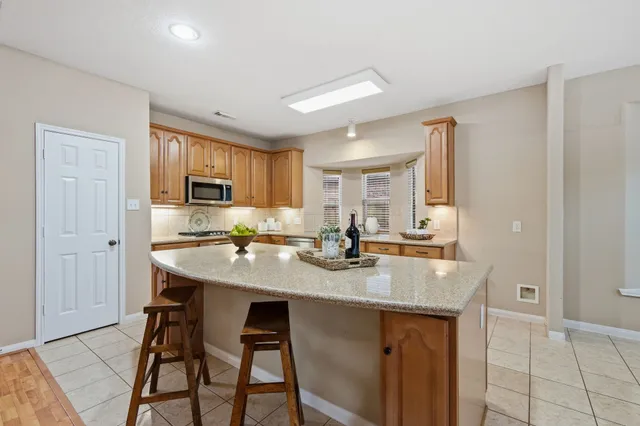 a kitchen with stainless steel appliances granite countertop a sink and cabinets
