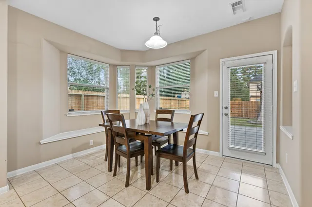 a view of a dining room with furniture window and outside view