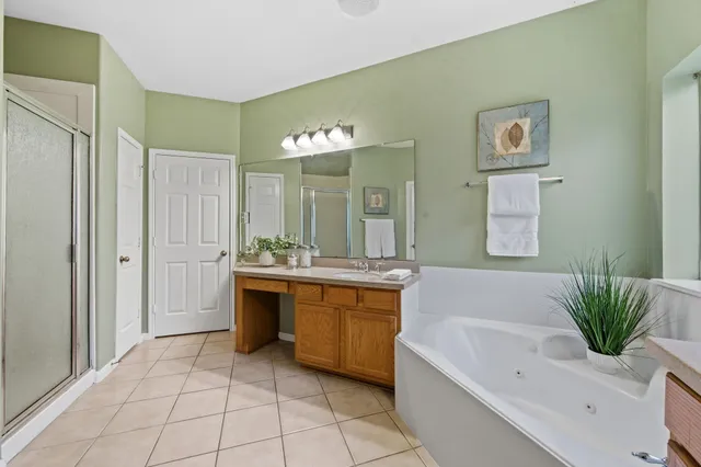 a spacious bathroom with a sink a bathtub and a mirror