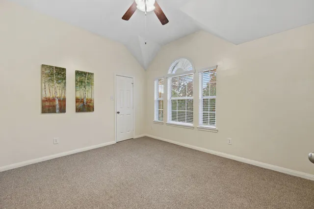 a bathroom with a granite countertop sink a toilet a mirror and shower