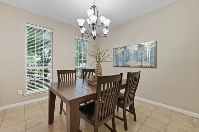 a view of a dining room with furniture and chandelier