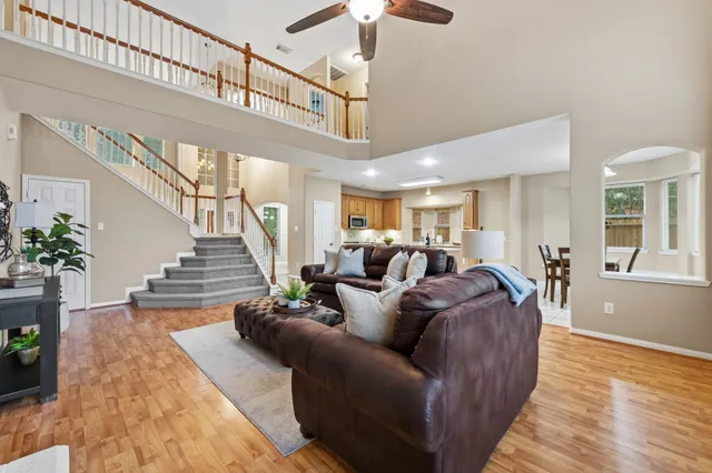a living room with furniture a fireplace and a chandelier