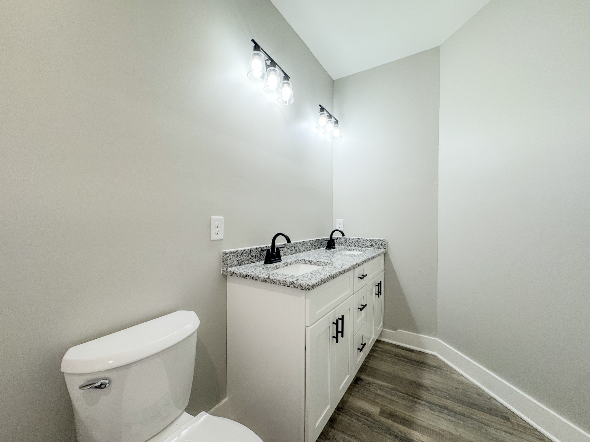 181 Rock House Hollow Road Bethpage, TN 37022 - Photo 28 of 51 a bathroom with a granite countertop sink a toilet and a mirror
