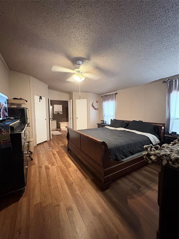 6295 Rendon New Hope Road Fort Worth, TX 76140 - Photo 21 of 38 Bedroom with light wood-style flooring, a ceiling fan, and a textured ceiling