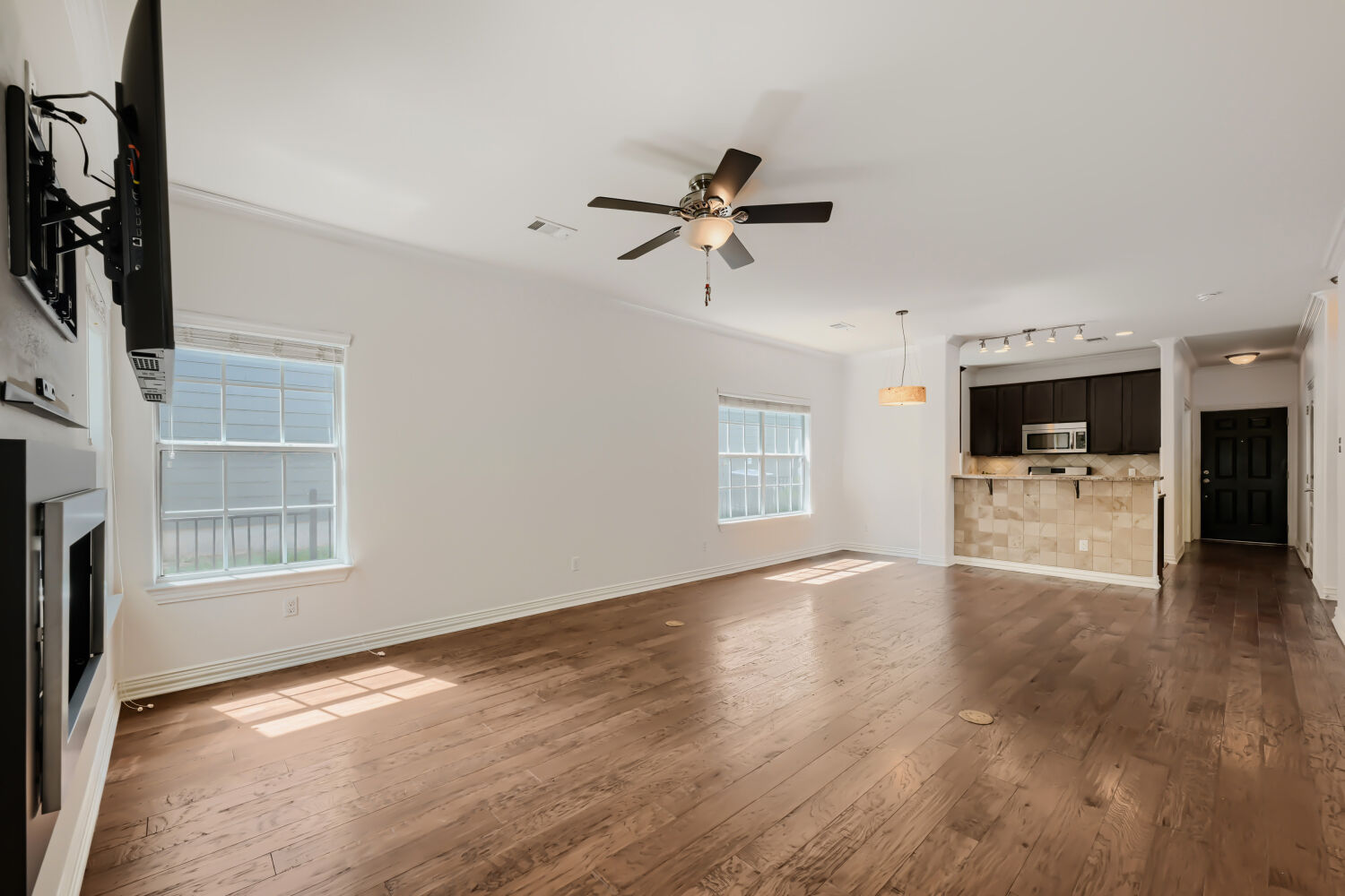 6715 Windrift Way, Unit 28 Austin, TX 78745 - Photo 7 of 19 Hand-scraped hardwood flooring stretches through this open-concept living area and kitchen, perfect for entertaining.