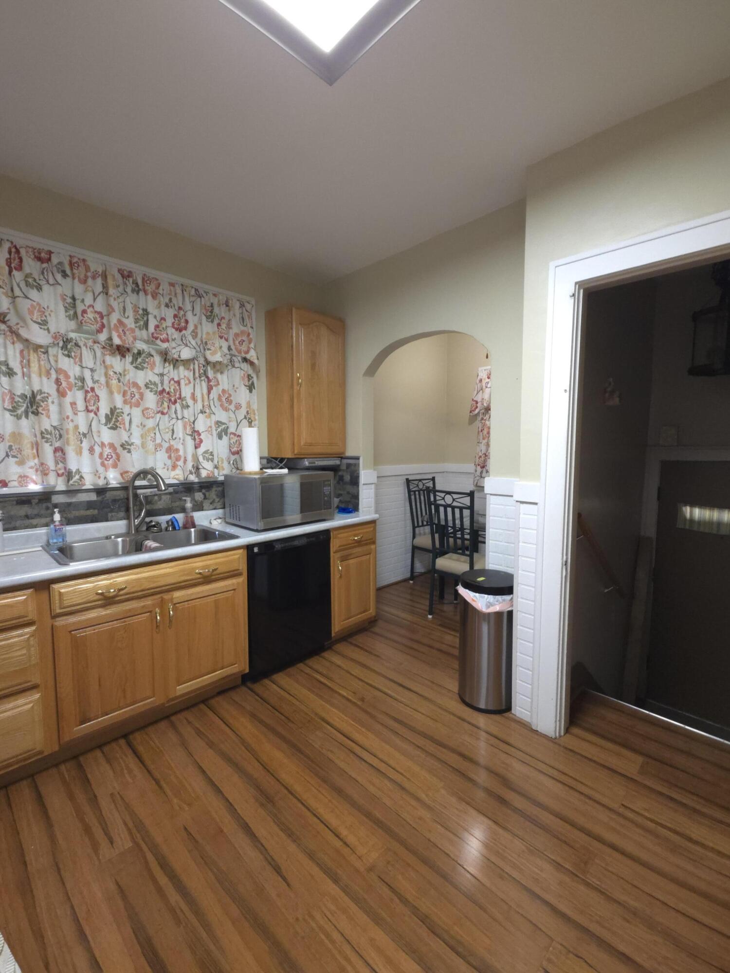 764 Hanley Street Gary, IN 46406 - Photo 6 of 15 a kitchen with stainless steel appliances kitchen island wooden cabinets and granite counter tops