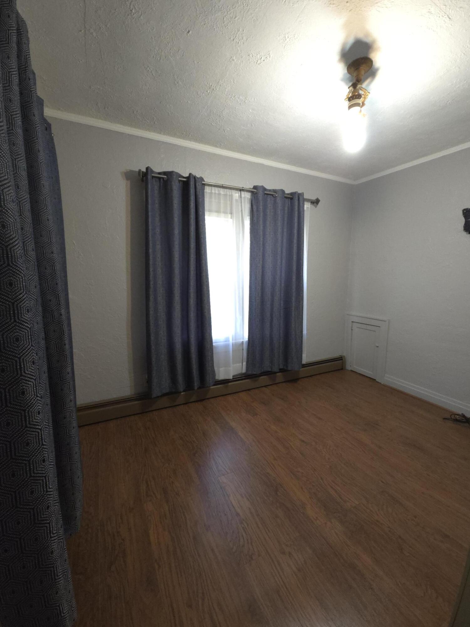 764 Hanley Street Gary, IN 46406 - Photo 8 of 15 an empty room with wooden floor and windows