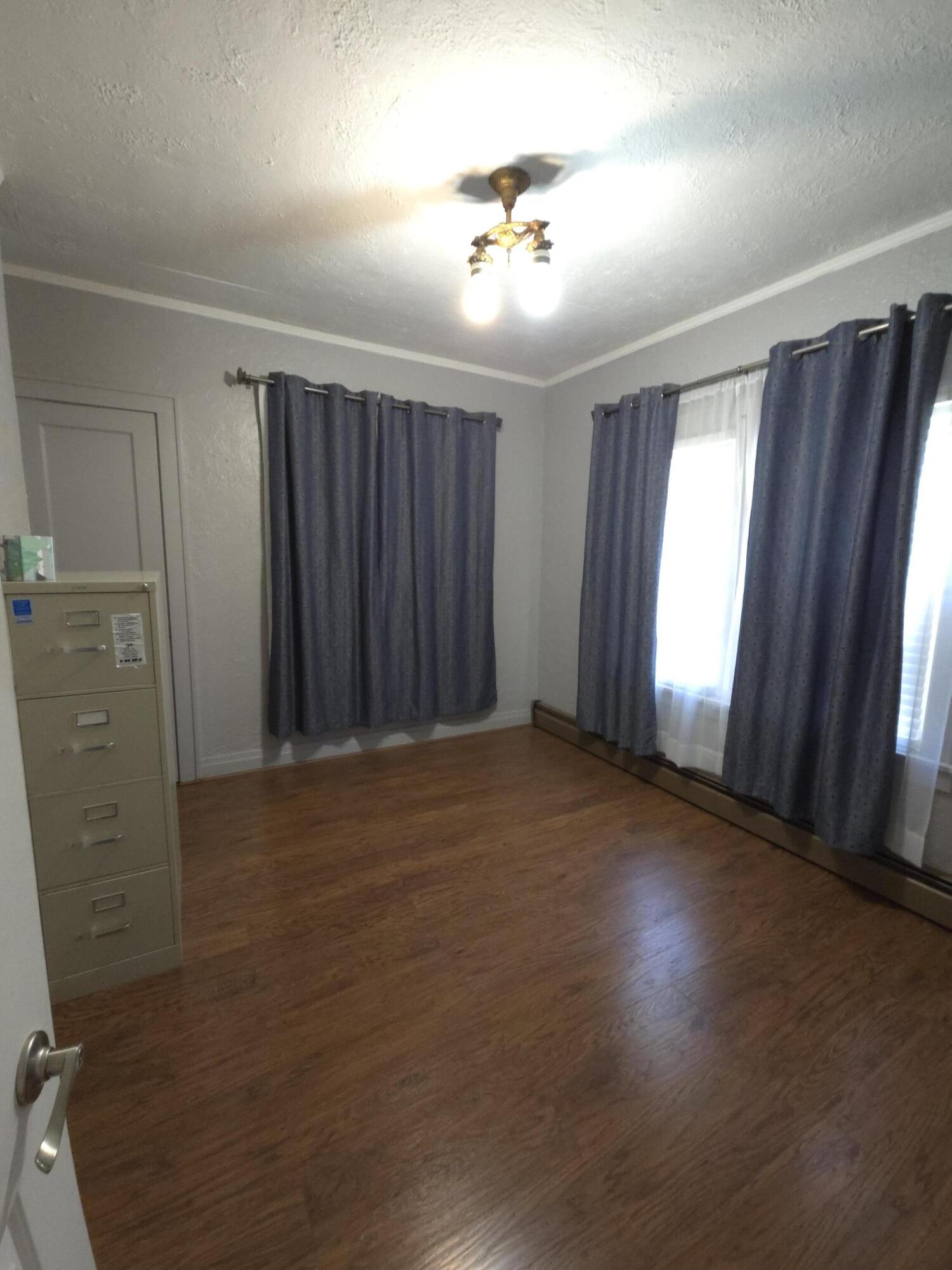 764 Hanley Street Gary, IN 46406 - Photo 10 of 15 an empty room with windows and hardwood floor