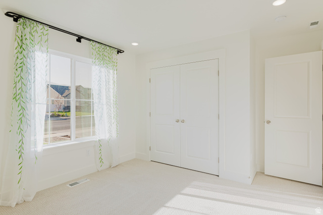 433 North 600 West Smithfield, UT 84335 - Photo 25 of 40 Bright interior space featuring a window with white framing, light-colored carpeting, recessed lighting, double panel doors, and a single panel door