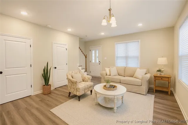 a living room with furniture a rug and a chandelier