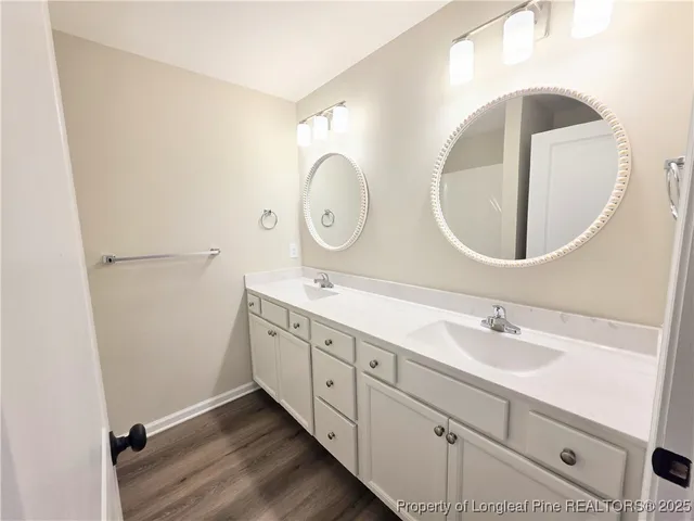 a bathroom with a double vanity sink and a mirror
