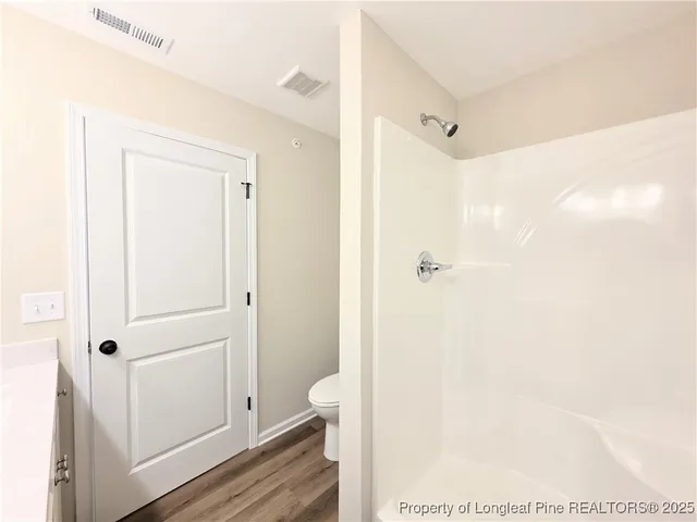 a bathroom with a shower and a toilet