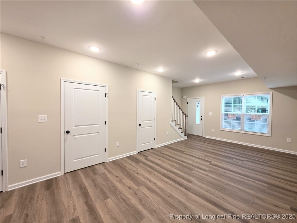 1511 Fort Bragg Road, Unit E Fayetteville, NC 28305 - Photo 8 of 17 an empty room with wooden floor and windows