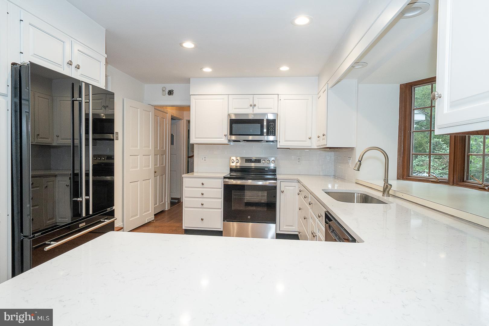 55 Wistar Road Villanova, PA 19085 - Photo 11 of 51 a kitchen with granite countertop a refrigerator and a stove top oven