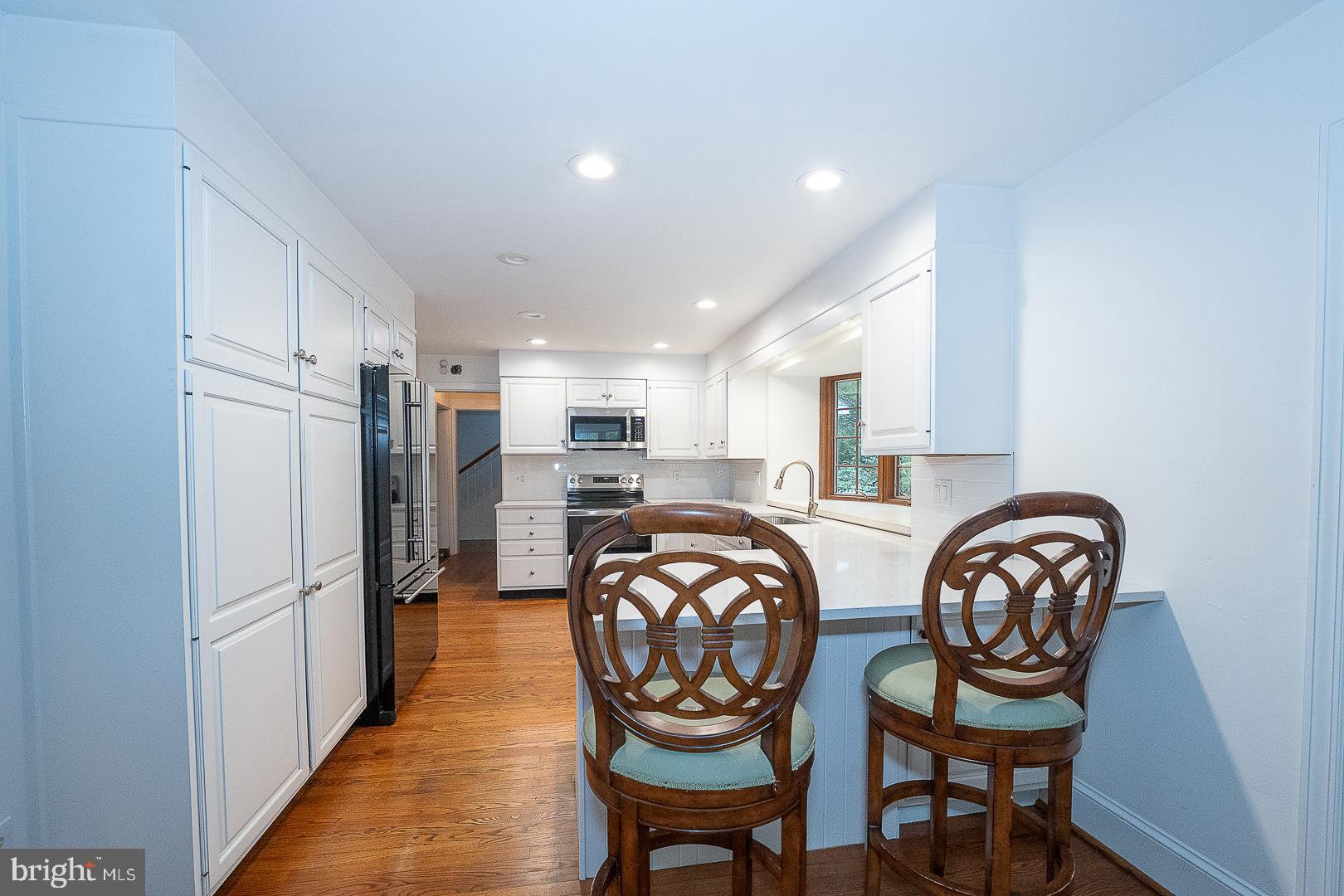 55 Wistar Road Villanova, PA 19085 - Photo 15 of 51 a large kitchen with dining table and stainless steel appliances