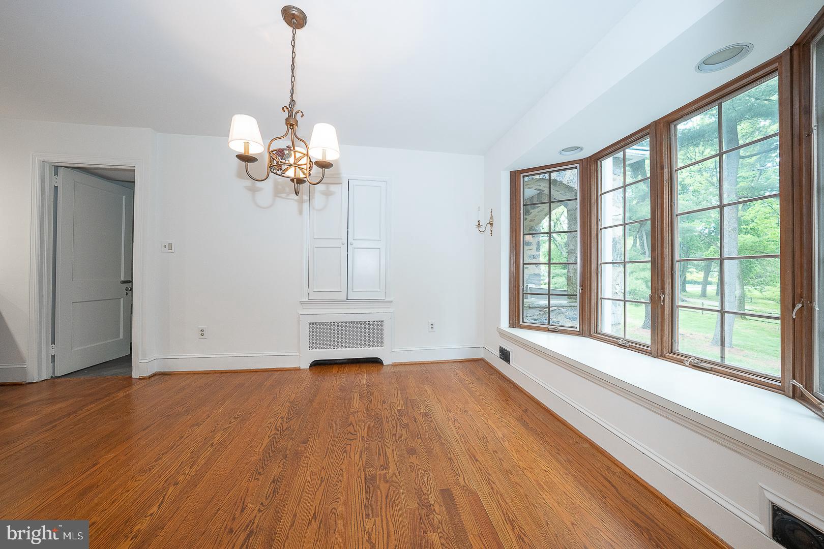 55 Wistar Road Villanova, PA 19085 - Photo 17 of 51 a view of an empty room with a window and wooden floor