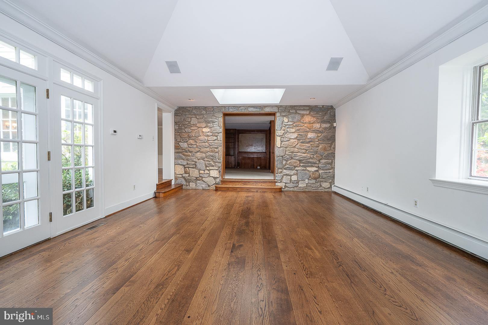 55 Wistar Road Villanova, PA 19085 - Photo 22 of 51 an empty room with wooden floor fireplace and windows