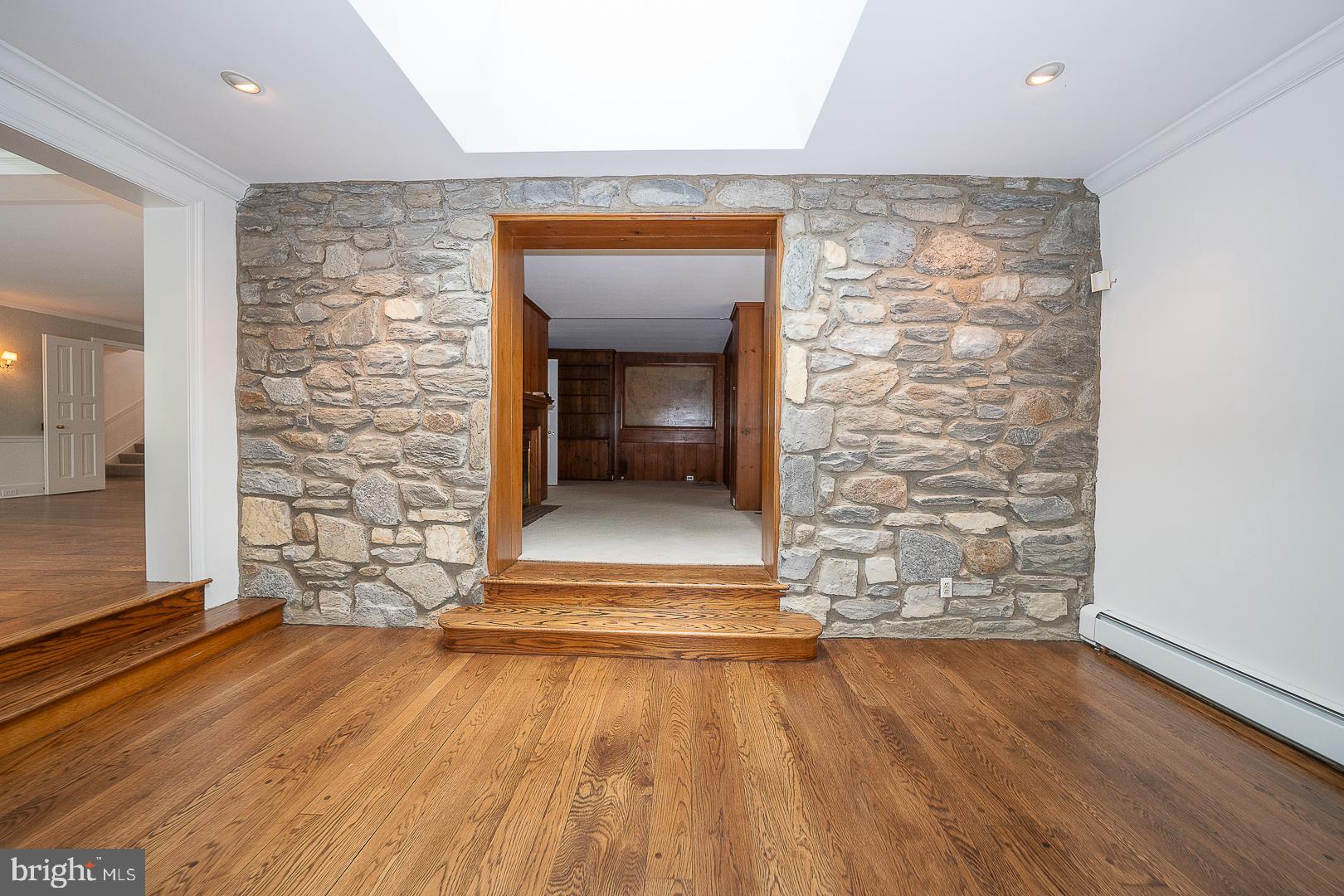 55 Wistar Road Villanova, PA 19085 - Photo 23 of 51 a view of a hallway with wooden floor and a fireplace