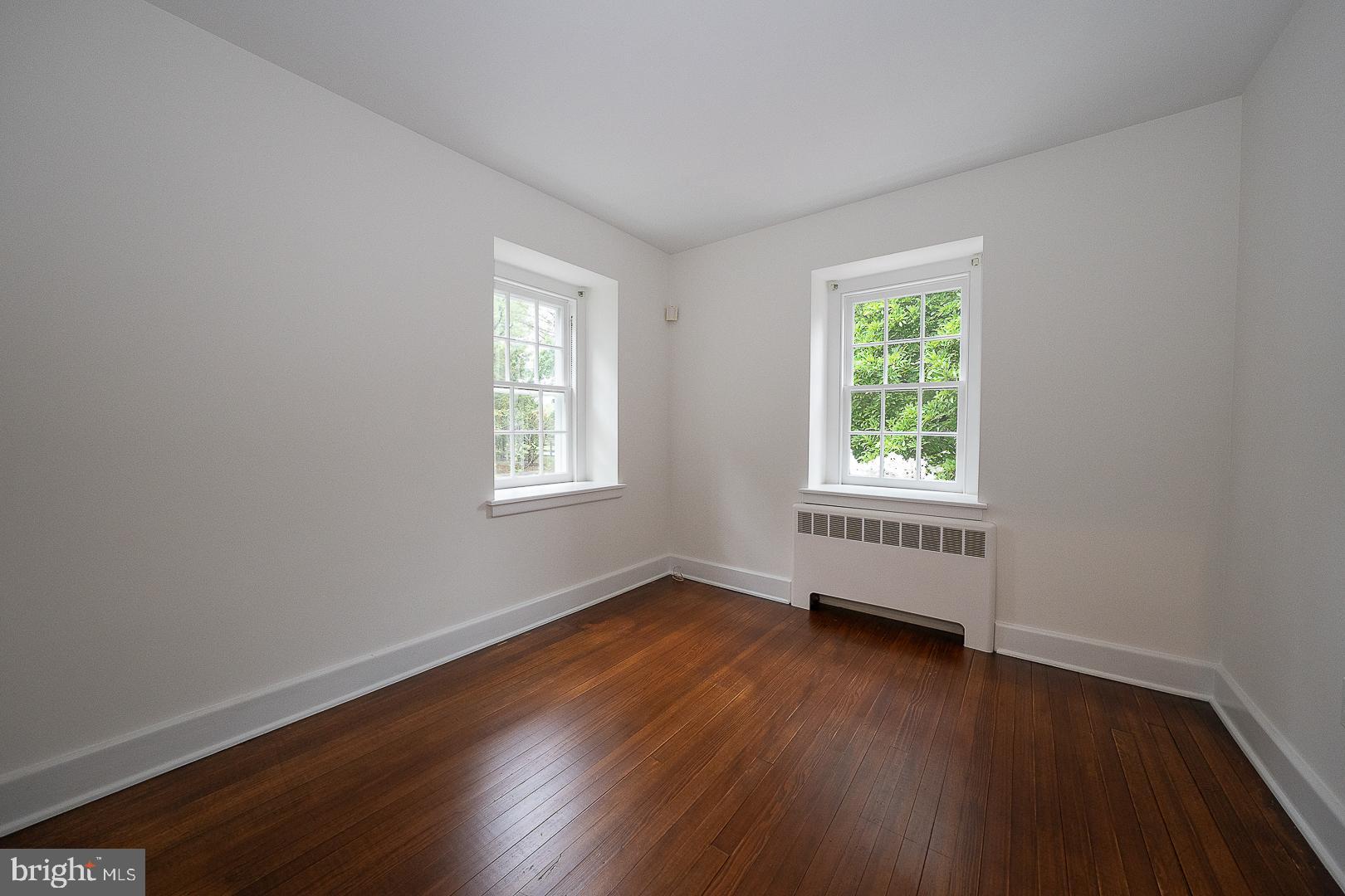 55 Wistar Road Villanova, PA 19085 - Photo 27 of 51 an empty room with wooden floor and windows