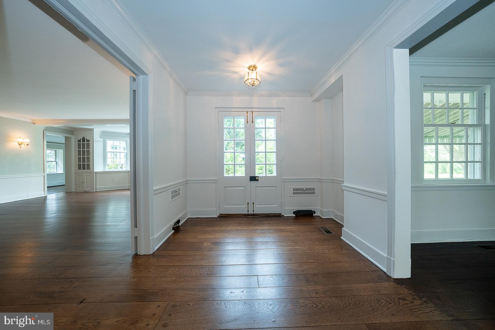55 Wistar Road Villanova, PA 19085 - Photo 3 of 51 a view of an empty room with wooden floor and a window