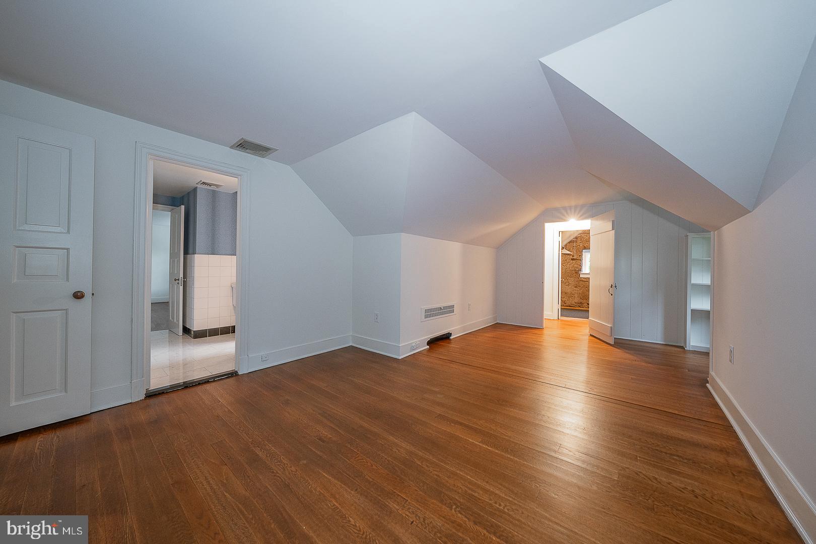 55 Wistar Road Villanova, PA 19085 - Photo 39 of 51 a view of an empty room with wooden floor and a window