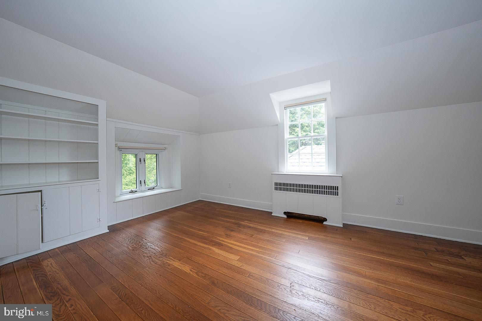 55 Wistar Road Villanova, PA 19085 - Photo 44 of 51 an empty room with wooden floor closet and windows