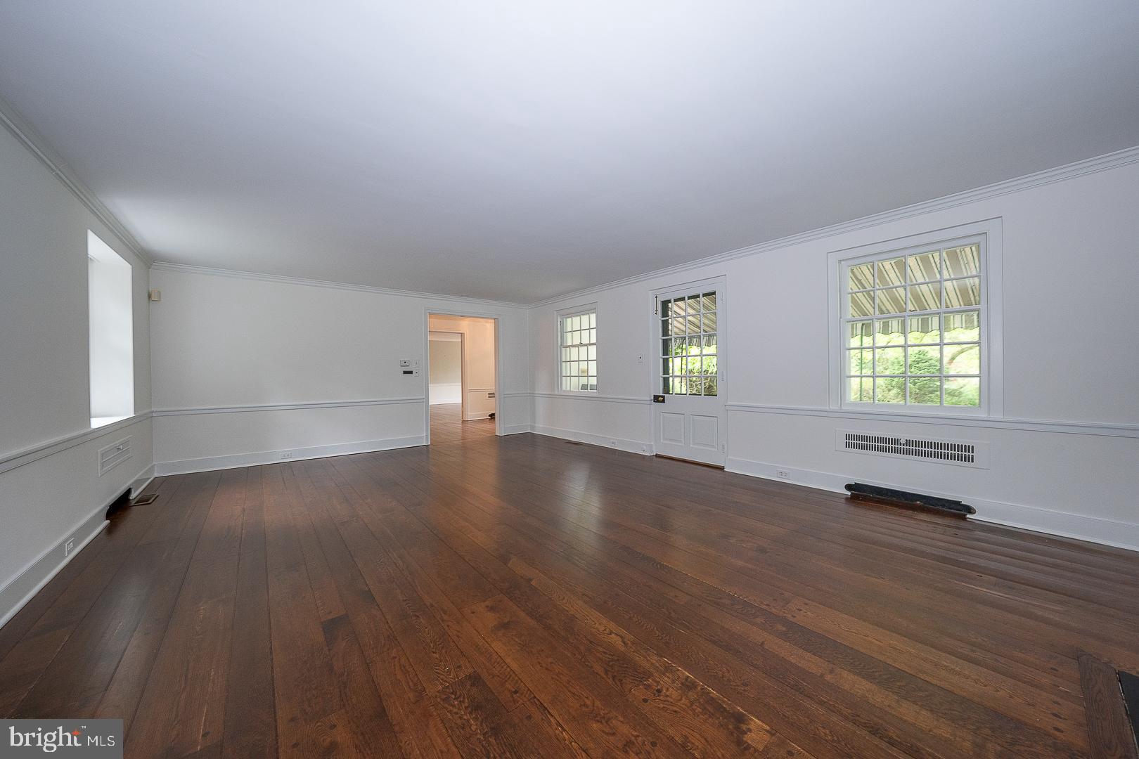 55 Wistar Road Villanova, PA 19085 - Photo 6 of 51 an empty room with wooden floor and windows