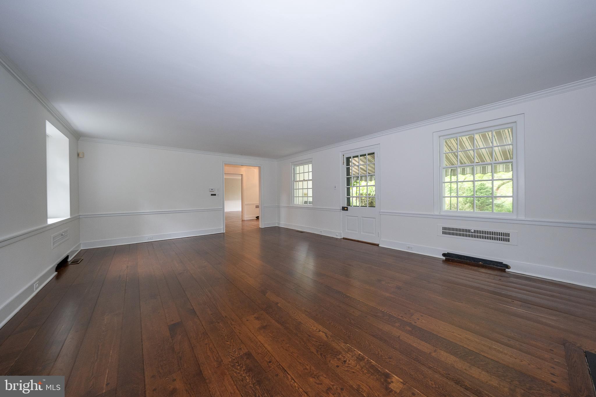 55 Wistar Road Villanova, PA 19085 - Photo 7 of 51 an empty room with wooden floor and windows